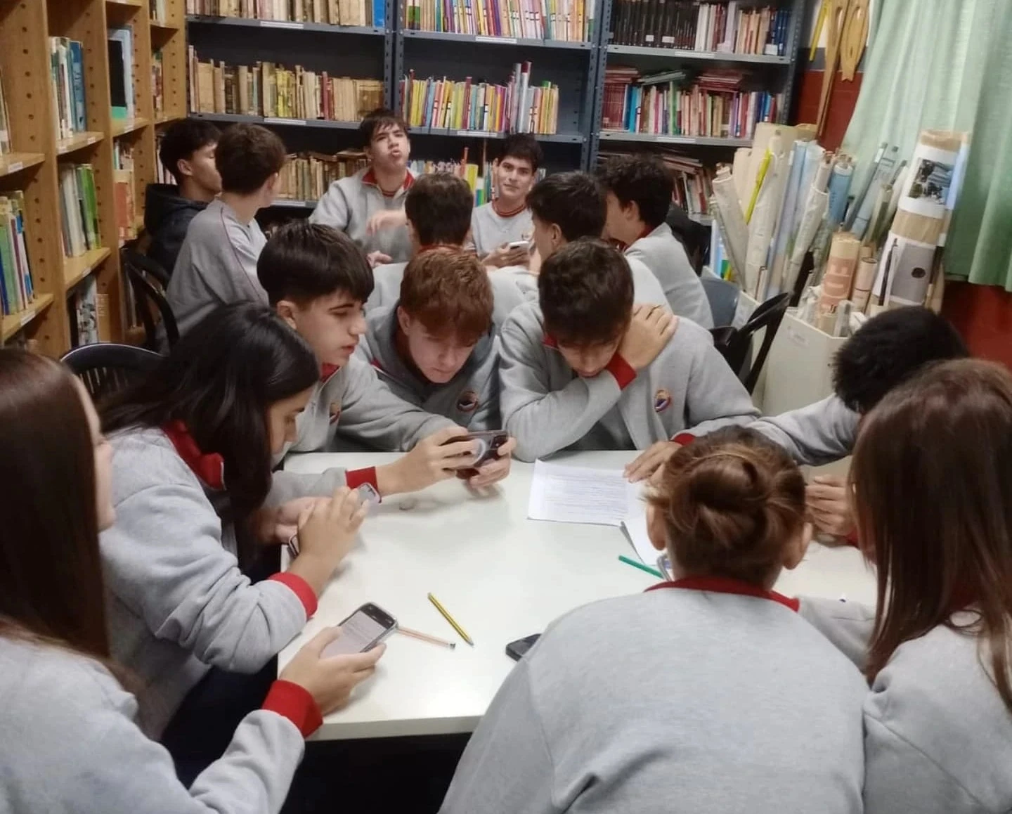 Estudiantes del Nivel Secundario del Colegio Alberdi participando en una actividad de investigación, análisis y trabajo colaborativo en la biblioteca escolar.